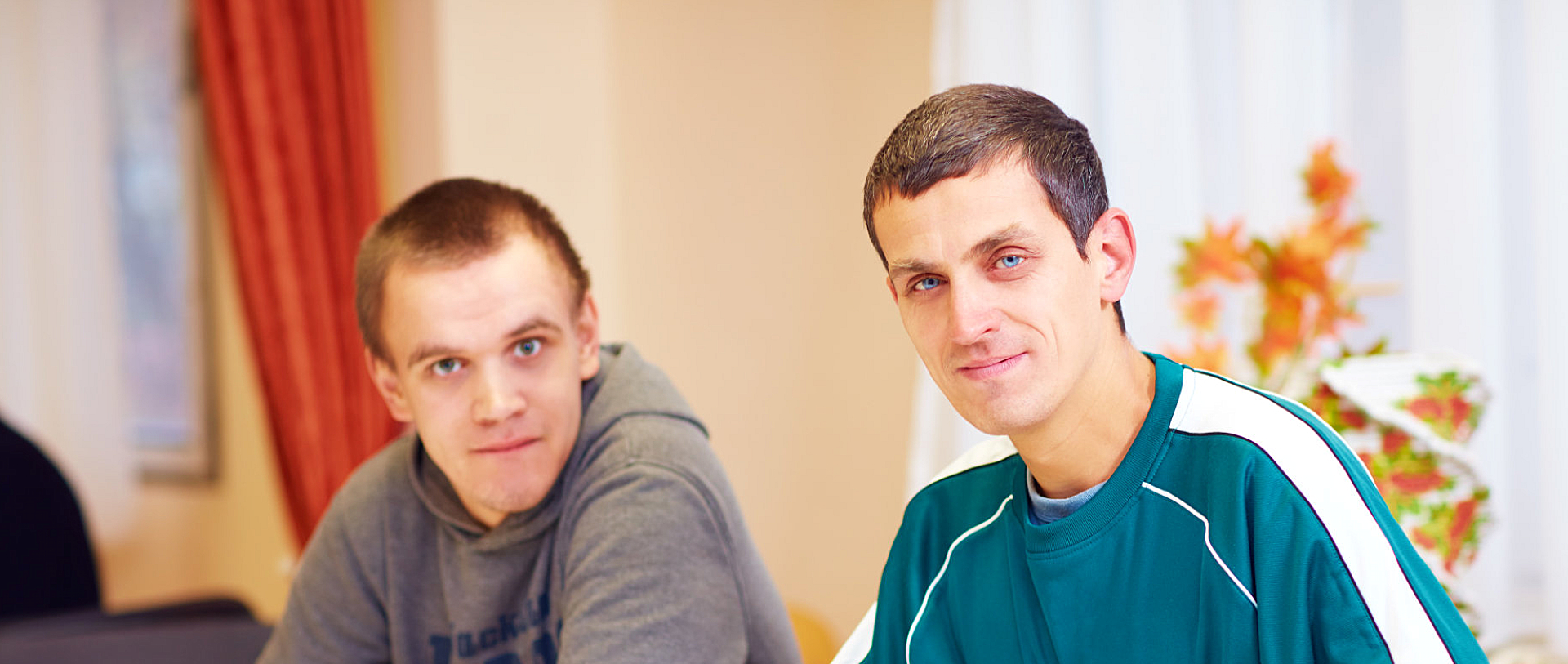 two men with disability smiling